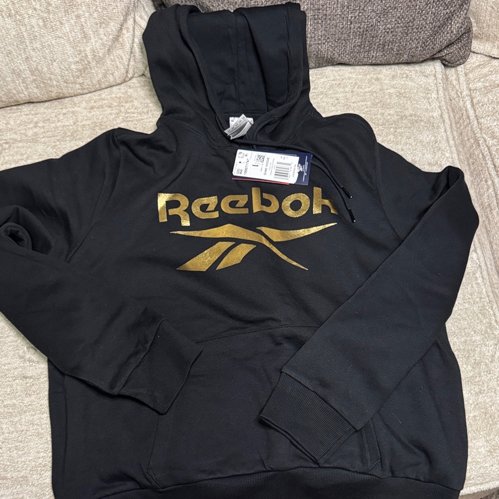 Reebok women’s Black Hoodie with Gold Logo